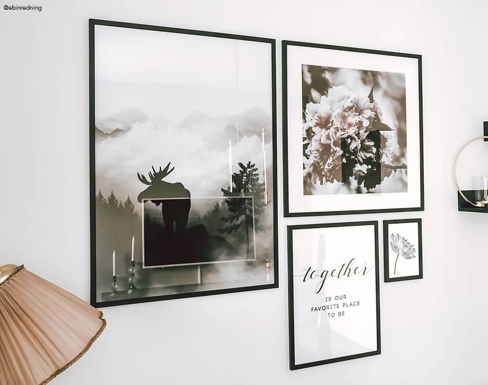 Picture wall with 5 black picture frames against a white wall